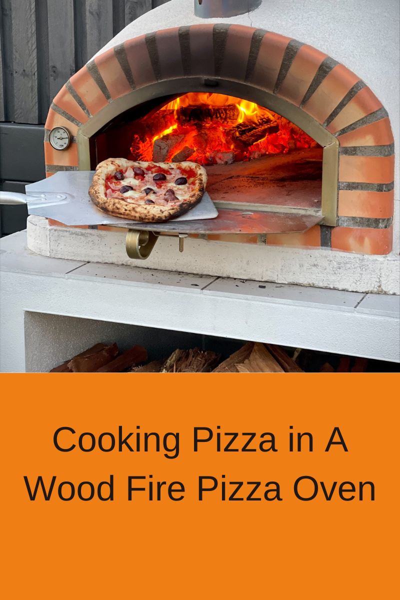 Cooking Pizza in A Wood Fire Pizza Oven